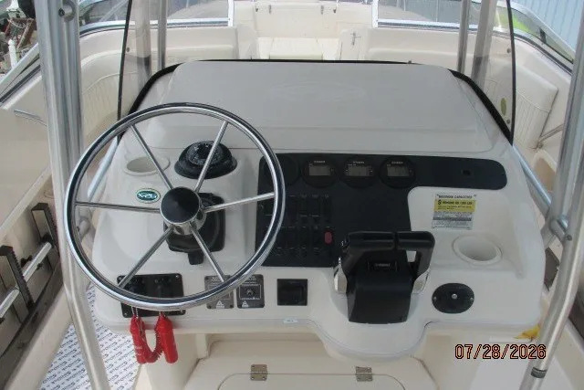 Slide: The Image of 2000 Grady-White F-26 Tigercat boat helm with steering wheel and control panel. - 29