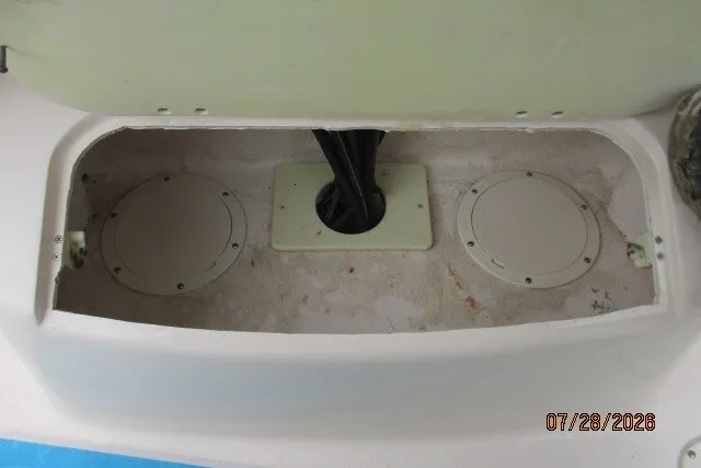 Slide: The Image of Storage compartment of 2000 Grady-White F-26 Tigercat boat, featuring circular access panels. - 10