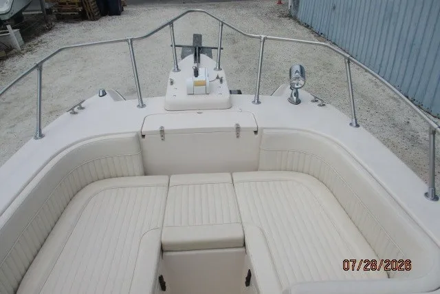 Slide: The Image of 2000 Grady-White F-26 Tigercat boat interior with cushioned seating and metal railings. - 41