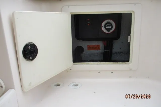 Slide: The Image of Open compartment on 2000 Grady-White F-26 Tigercat boat showing electrical panel. - 23