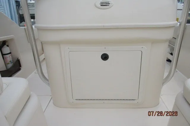 Slide: The Image of 2000 Grady-White F-26 Tigercat boat interior with storage compartment and fire extinguisher. - 49