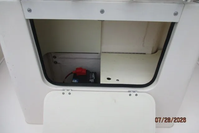 Slide: The Image of Open storage compartment on a 2000 Grady-White F-26 Tigercat boat, showing interior details. - 28