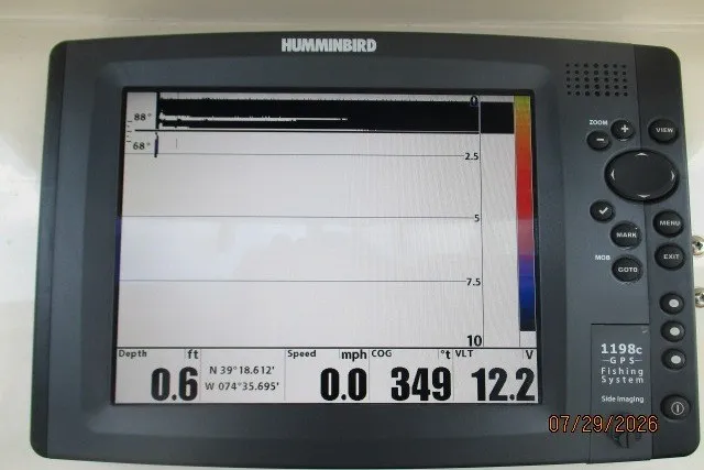 Slide: The Image of Humminbird GPS fishing system display on Grady-White X-26 Tigercat, showing depth and coordinates. - 7
