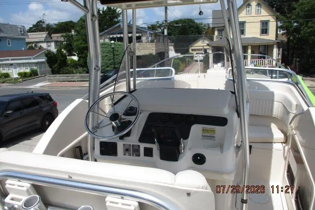 Slide: The Image of 2000 Grady-White X-26 Tigercat boat interior with steering wheel and control panel. - 65