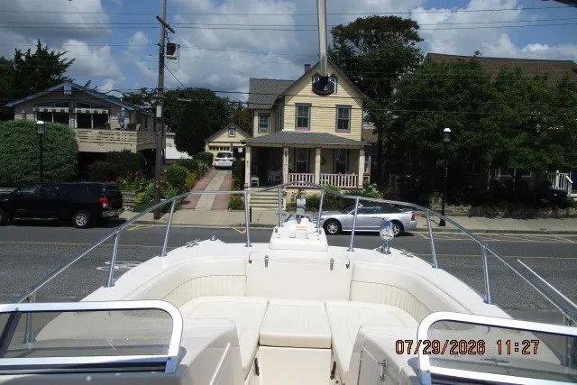 Slide: The Image of Grady-White X-26 Tigercat boat docked near residential street, sunny day, 2000 model. - 54