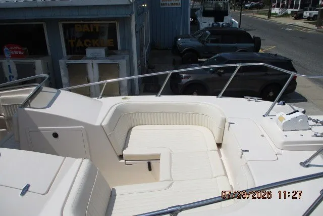 Slide: The Image of 2000 Grady-White X-26 Tigercat boat with seating area, docked near bait and tackle shop. - 64