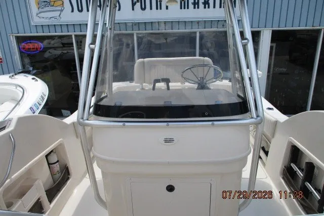 Slide: The Image of Grady-White X-26 Tigercat 2000 boat cockpit with steering wheel, docked at marina. - 55