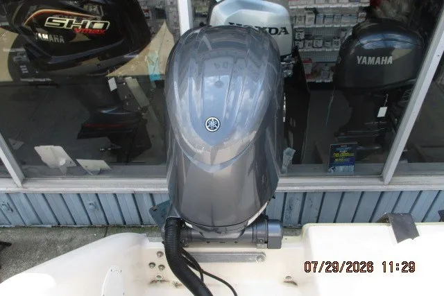 Slide: The Image of Outboard motor display with Yamaha branding, viewed from above, in a marine shop setting. - 58