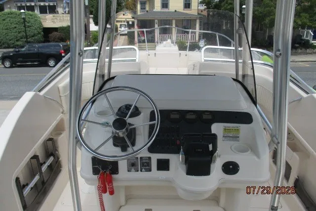 Slide: The Image of 2000 Grady-White X-26 Tigercat boat helm with steering wheel and control panel. - 27