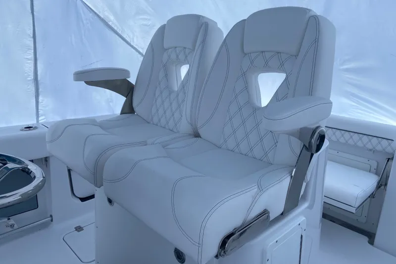 Slide: The Image of Luxury seating on 2027 Sportsman Open 262 Center Console boat, featuring elegant white upholstery. - 7