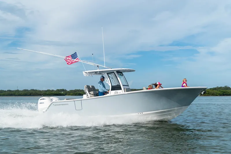 The Image of 2027 Sportsman Open 262 Center Console boat cruising on water with passengers. - 0