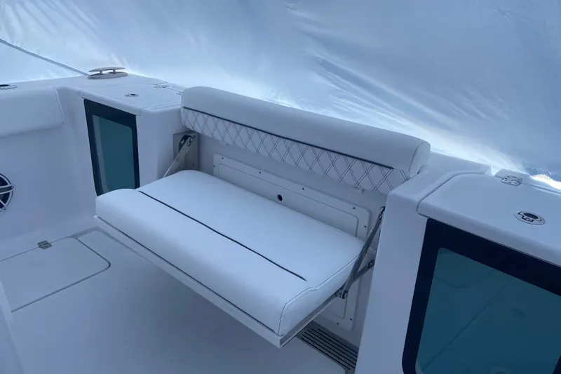 Slide: The Image of 2027 Sportsman Open 262 Center Console boat interior with white cushioned seating. - 4
