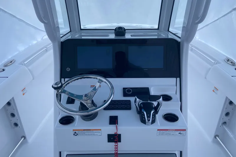 Slide: The Image of 2027 Sportsman Open 262 Center Console helm with dual screens and steering wheel. - 8