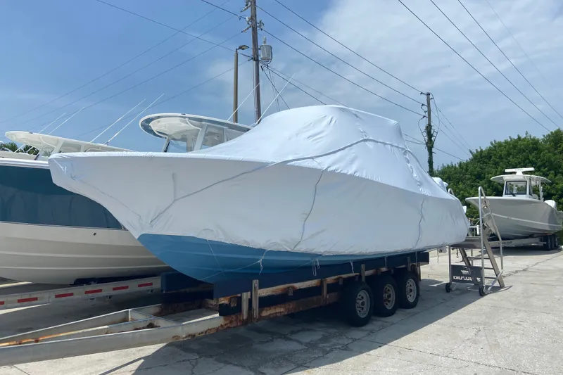 Slide: The Image of 2027 Sportsman Open 262 Center Console boat covered on trailer, ready for transport. - 2