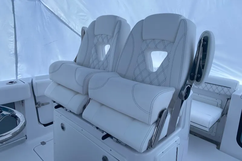 Slide: The Image of 2027 Sportsman Open 262 Center Console boat seats, featuring luxurious white upholstery. - 6