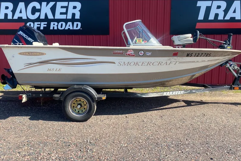 The Image of 2003 Smoker Craft Pro Angler 165 SC boat on trailer, parked outdoors. - 1