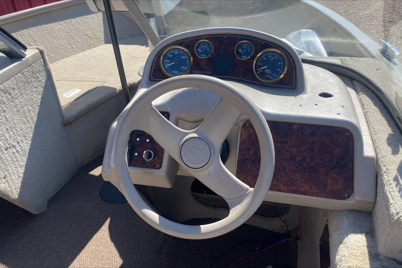 Slide: The Image of 2003 Smoker Craft Pro Angler 165 SC boat dashboard with steering wheel and gauges. - 5