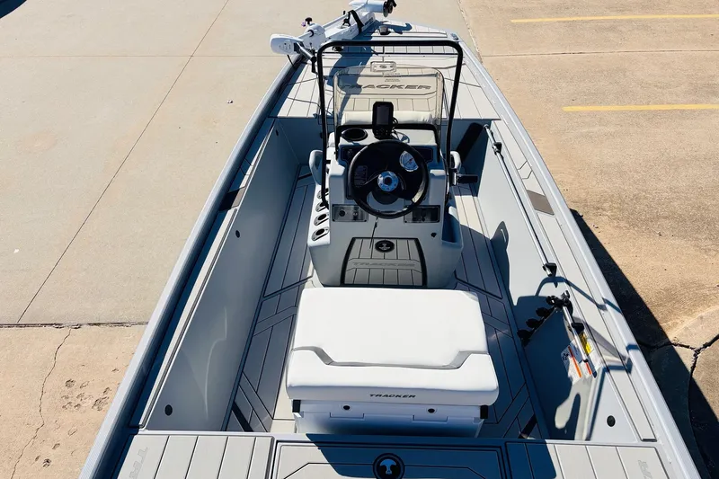 Slide: The Image of 2027 Tracker Bass Tracker Classic CC boat interior with steering console and seating. - 9