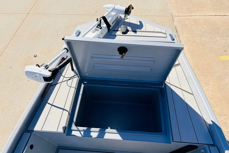 Slide: The Image of 2027 Tracker Bass Tracker Classic CC boat with open storage compartment and trolling motor. - 13