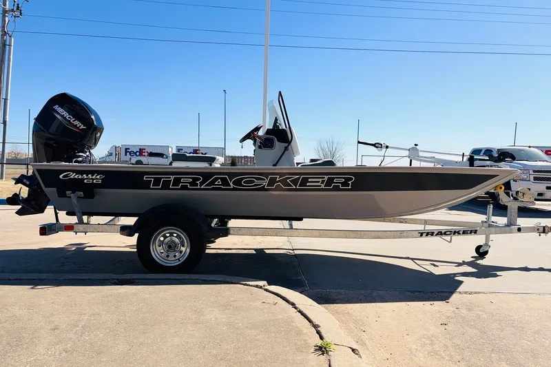 Slide: The Image of 2027 Tracker Bass Tracker Classic CC boat on trailer, side view in sunny outdoor setting. - 5