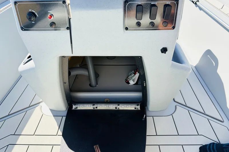 Slide: The Image of 2027 Tracker Bass Tracker Classic CC boat console with open storage compartment and control panel. - 23