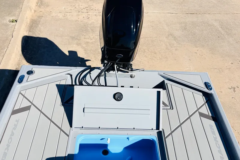 Slide: The Image of 2027 Tracker Bass Tracker Classic CC boat with open storage compartment and motor, viewed from above. - 30