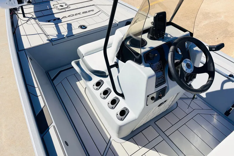 Slide: The Image of 2027 Tracker Bass Tracker Classic CC boat interior with steering console and rod holders. - 18