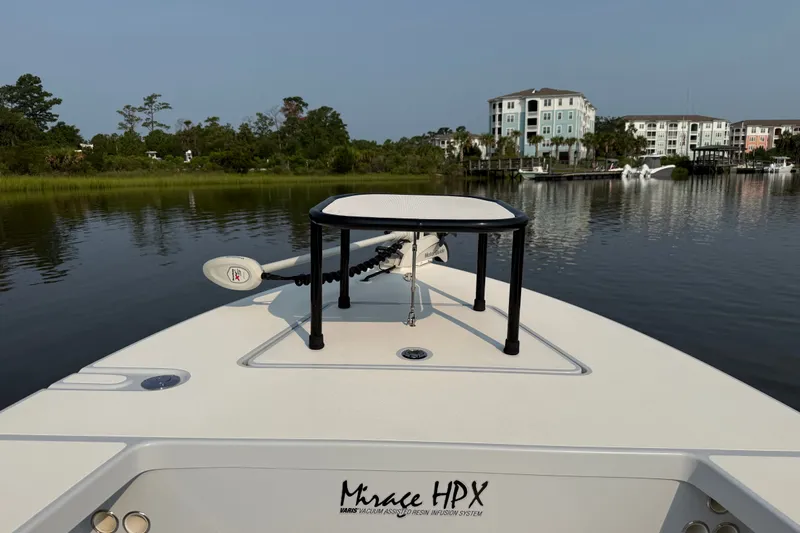 Slide: The Image of 2020 Maverick 18 HPX-V boat on calm water near residential buildings. - 26