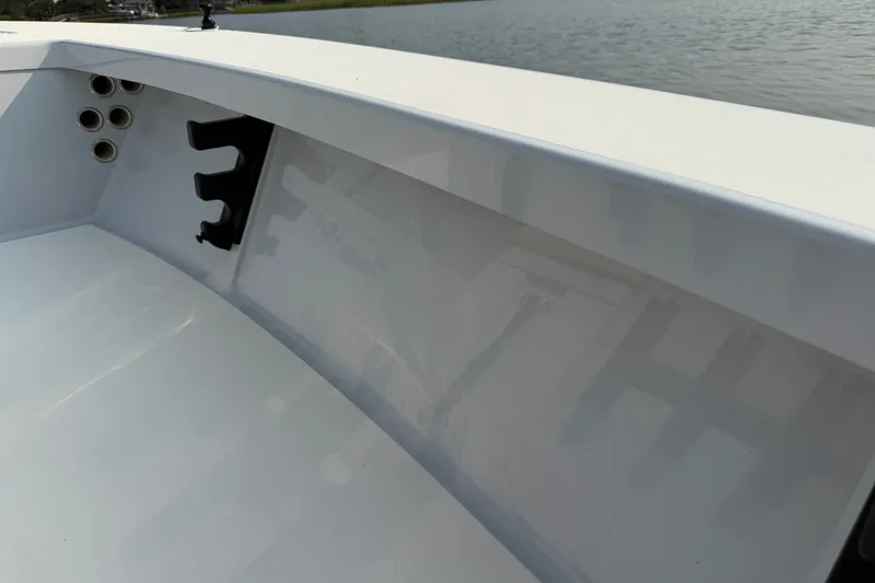 Slide: The Image of 2020 Maverick 18 HPX-V boat interior with rod holders, near calm water. - 32