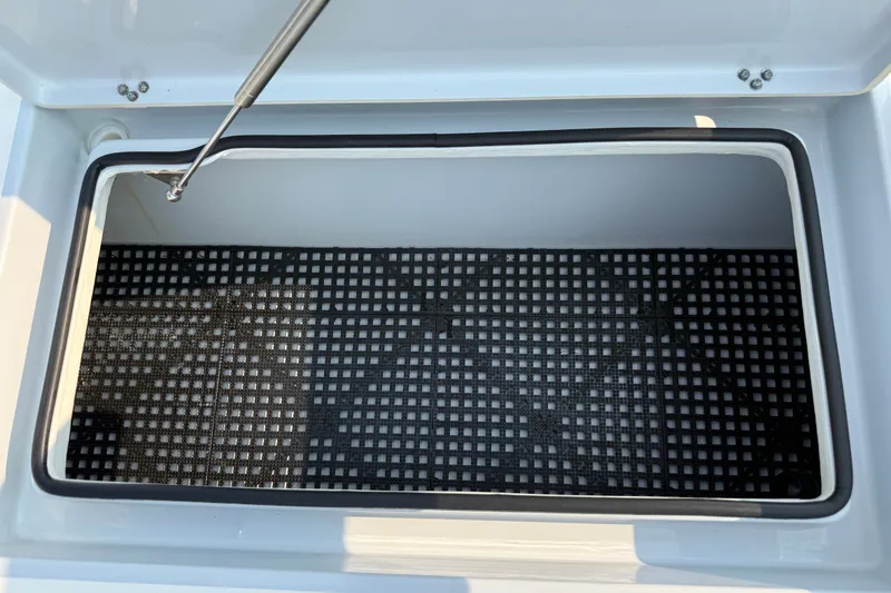 Slide: The Image of Open storage compartment of 2020 Maverick 18 HPX-V boat with black grid mat. - 35