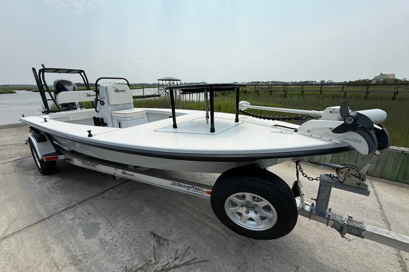 Slide: The Image of 2020 Maverick 18 HPX-V boat on trailer by waterfront, featuring MotorGuide trolling motor. - 7