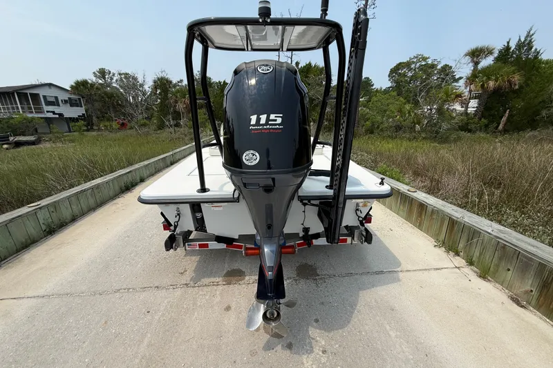 Slide: The Image of 2020 Maverick 18 HPX-V boat with 115 horsepower engine, parked on a concrete path. - 11