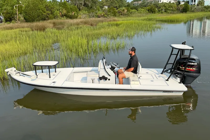 Slide: The Image of 2020 Maverick 18 HPX-V boat with Yamaha engine on calm water. - 2