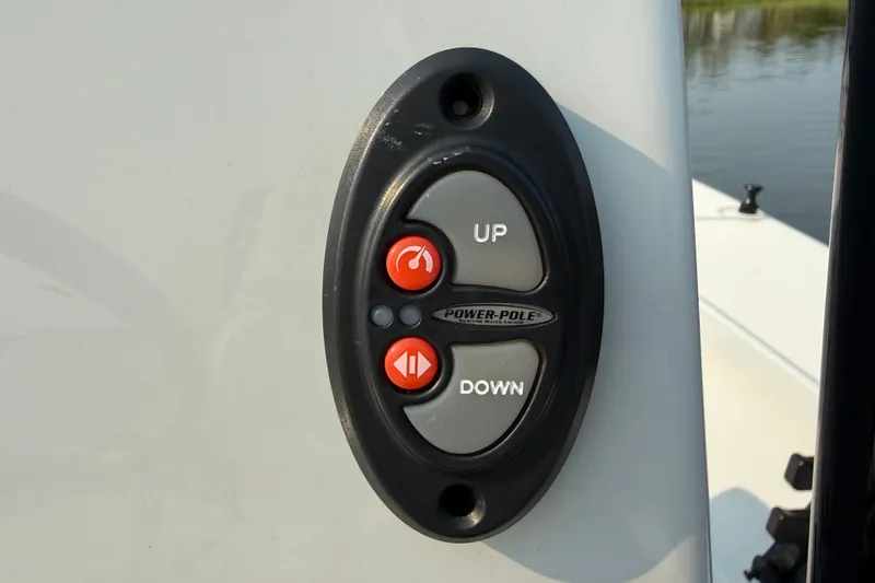 Slide: The Image of Power-Pole control panel on 2020 Maverick 18 HPX-V boat, featuring up and down buttons. - 42