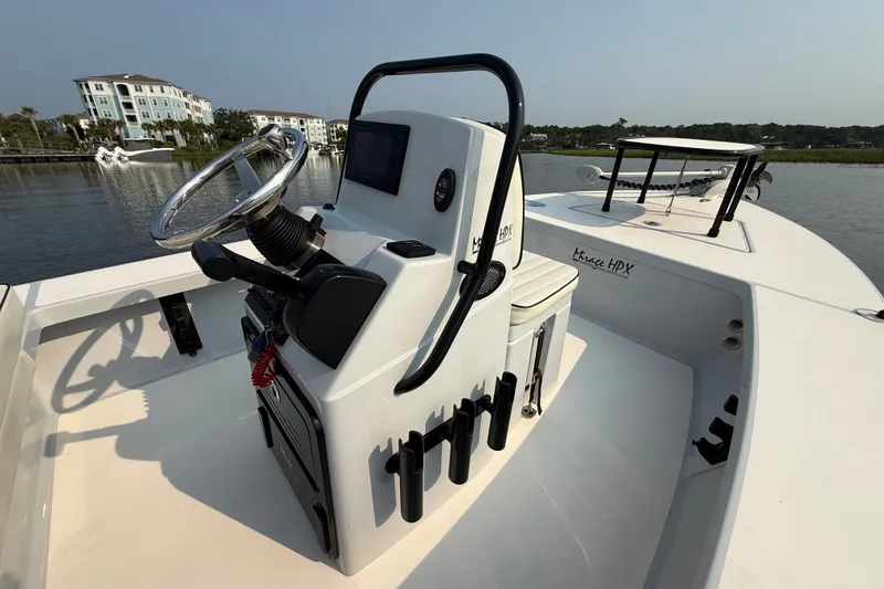 Slide: The Image of 2020 Maverick 18 HPX-V boat with sleek console design, docked near waterfront buildings. - 23