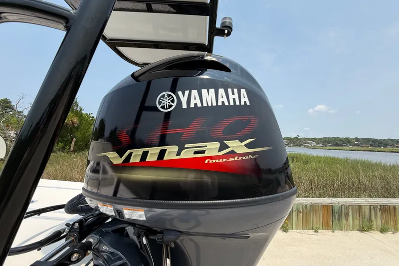 Slide: The Image of Yamaha VMAX outboard motor on 2020 Maverick 18 HPX-V boat by the water. - 13