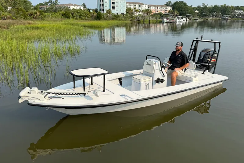 Slide: The Image of 2020 Maverick 18 HPX-V boat on calm water with a person at the helm. - 3