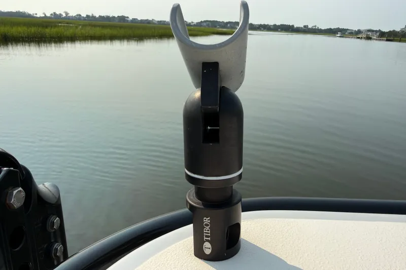 Slide: The Image of Fishing rod holder on 2020 Maverick 18 HPX-V boat, overlooking serene waterway. - 45