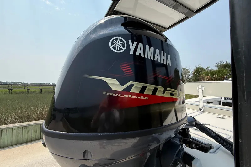 Slide: The Image of Yamaha VMAX four-stroke engine on 2020 Maverick 18 HPX-V boat, docked outdoors. - 14