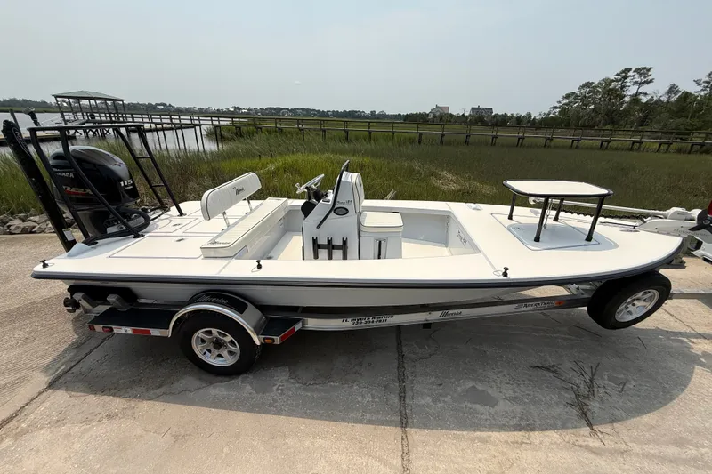 Slide: The Image of 2020 Maverick 18 HPX-V boat on trailer by waterfront, featuring sleek design and Yamaha engine. - 6