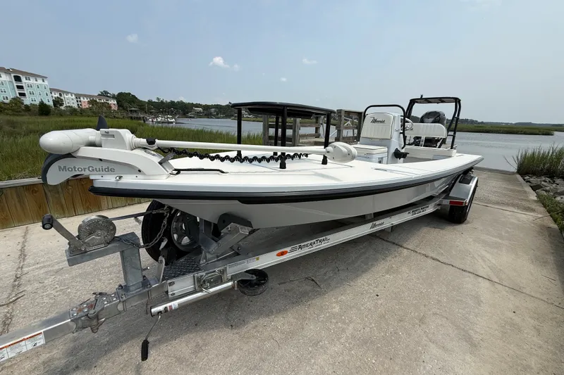 Slide: The Image of 2020 Maverick 18 HPX-V boat on trailer near waterfront, featuring MotorGuide trolling motor. - 9