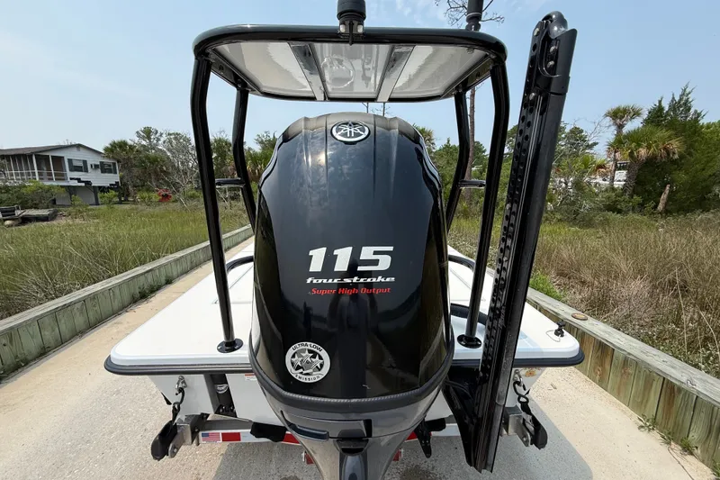 Slide: The Image of 2020 Maverick 18 HPX-V boat with Yamaha 115 four-stroke engine, parked outdoors. - 12