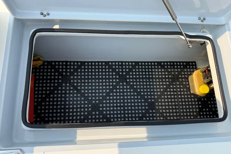Slide: The Image of Open storage compartment in 2020 Maverick 18 HPX-V boat with grid flooring. - 36