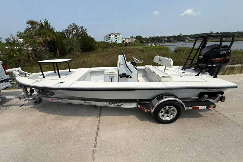 Slide: The Image of 2020 Maverick 18 HPX-V boat on trailer, parked near a scenic waterfront area. - 8