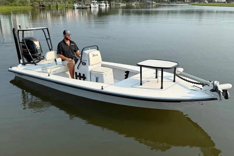 Slide: The Image of 2020 Maverick 18 HPX-V boat on calm water with a person at the helm. - 1