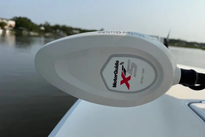 Slide: The Image of MotorGuide X5 trolling motor on 2020 Maverick 18 HPX-V boat, near calm waters. - 29