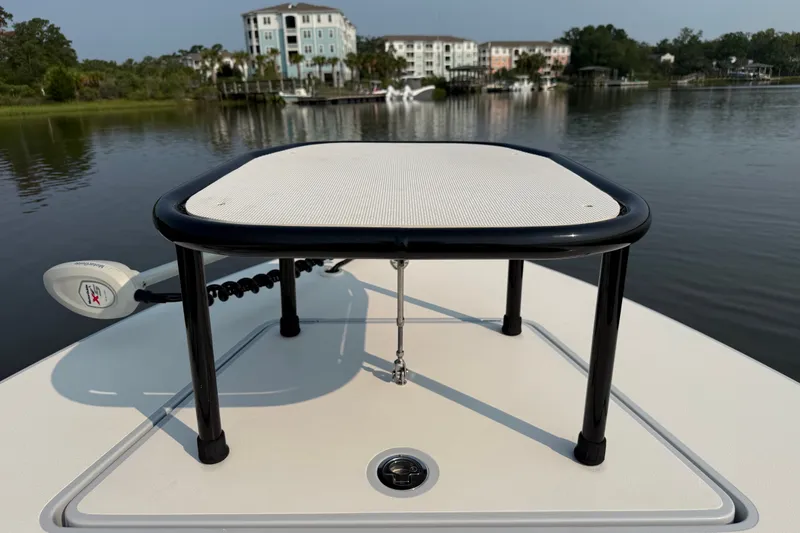 Slide: The Image of 2020 Maverick 18 HPX-V boat with casting platform on calm water, residential backdrop. - 27