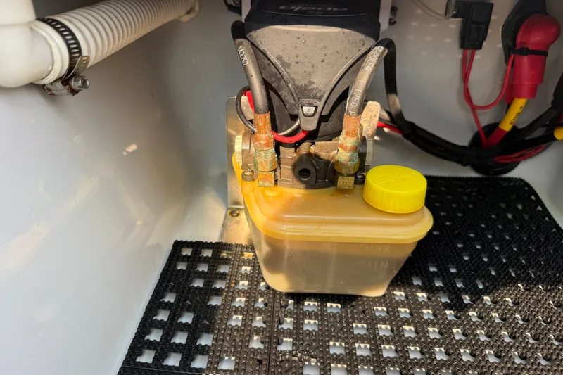 Slide: The Image of 2020 Maverick 18 HPX-V boat hydraulic system with fluid reservoir and wiring connections. - 44