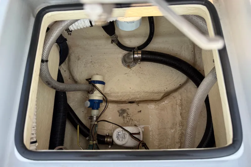 Slide: The Image of 2020 Maverick 18 HPX-V boat compartment with hoses and pump system. - 46
