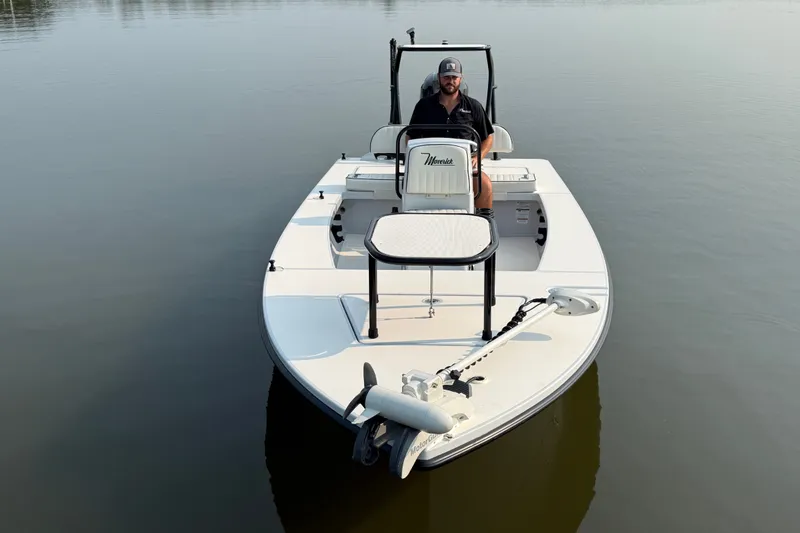 Slide: The Image of 2020 Maverick 18 HPX-V boat on calm water with a person seated at the helm. - 4